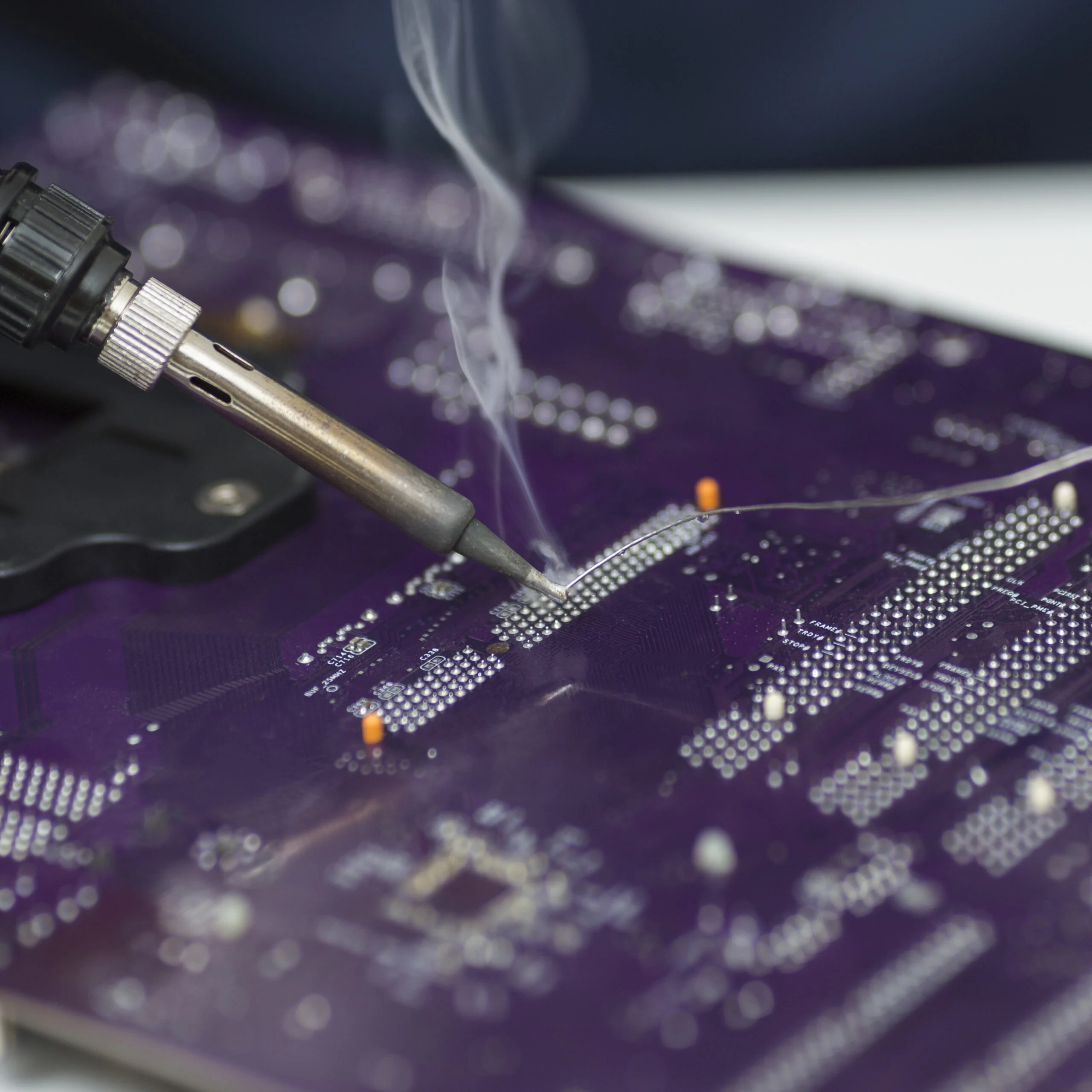 Technician soldering a printed circuit board