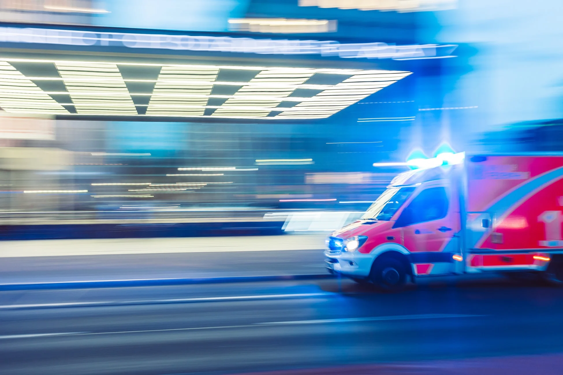 Ambulance moving through a city at night