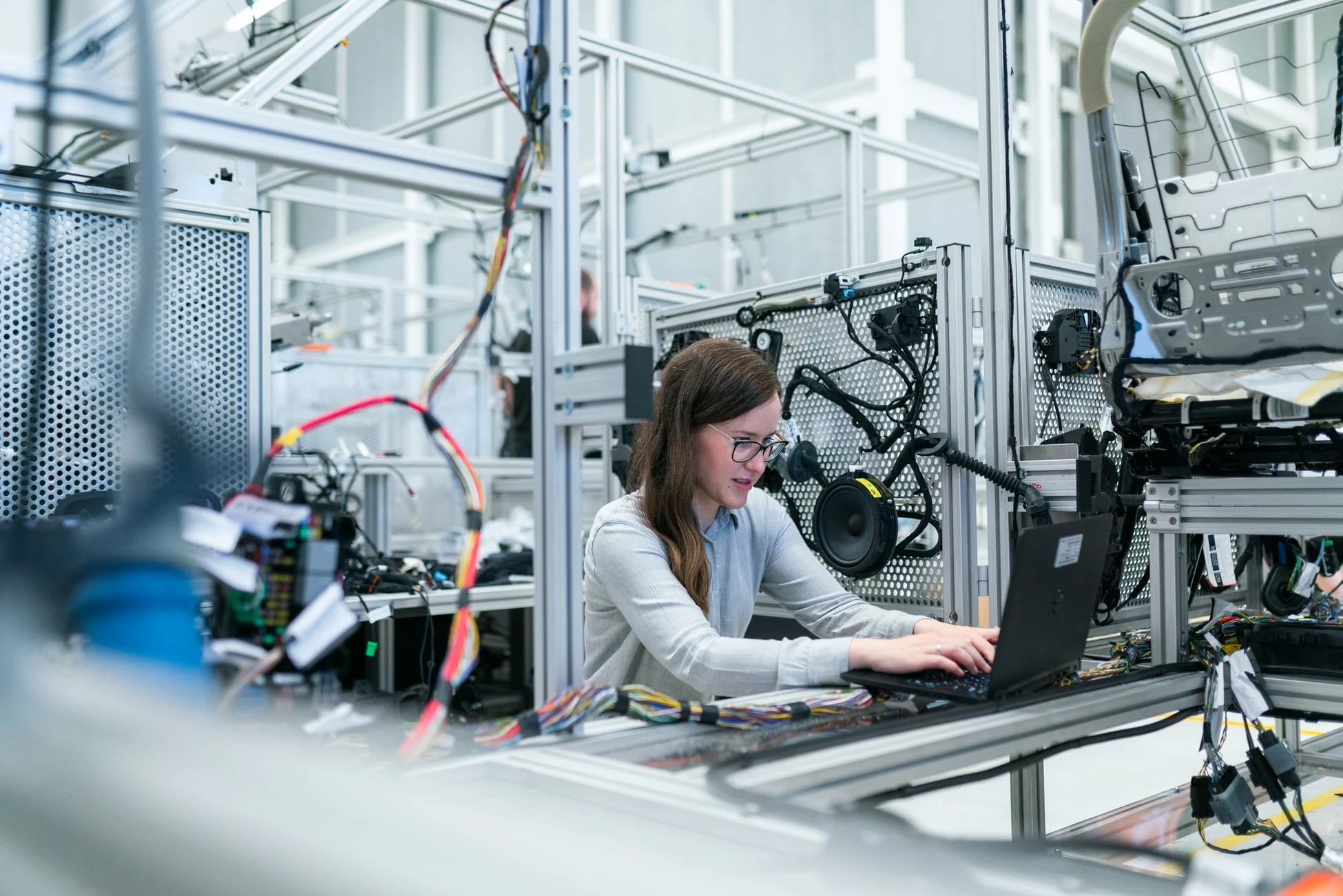 Incito-TPM-Featured Technician working on industrial equipment in a manufacturing plant