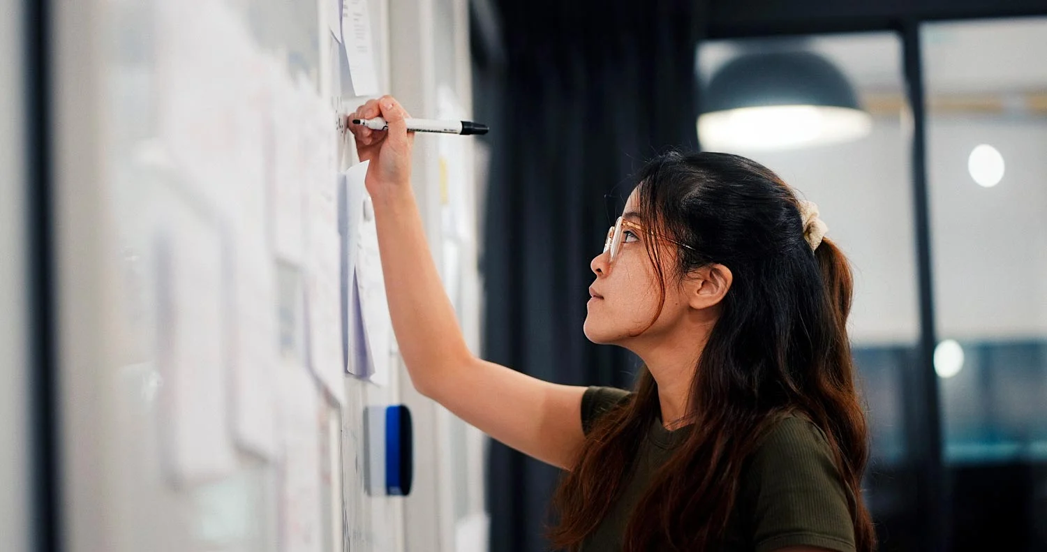 Incito-What-Is-Lean-Visual-Management-1500p-Hero Professional writing on a transparent planning board